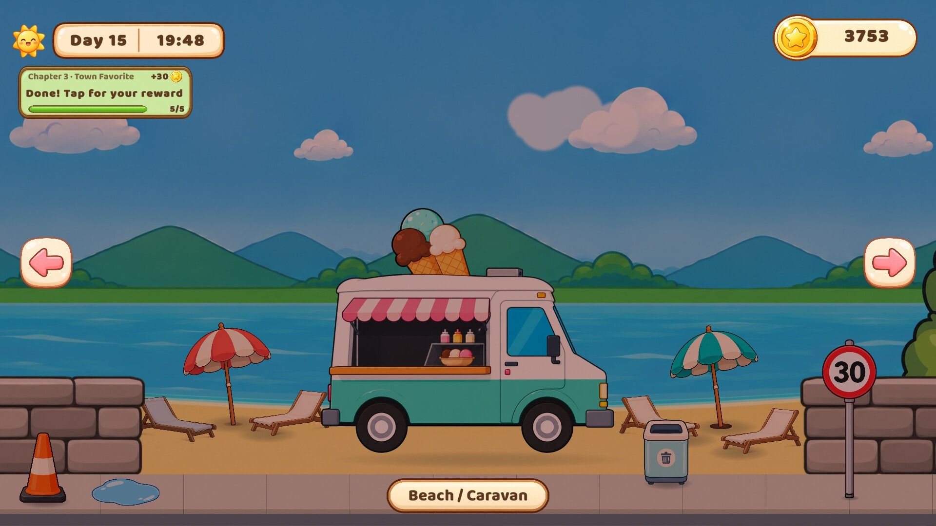 The turquoise ice cream truck parked on a sunny beach, with umbrellas and the sea behind it.